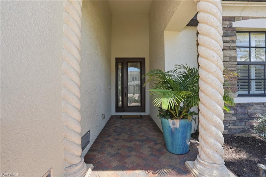 3058 Aviamar Circle Naples, FL 34114 - Photo 27 of 50 Covered entryway with textured stucco walls