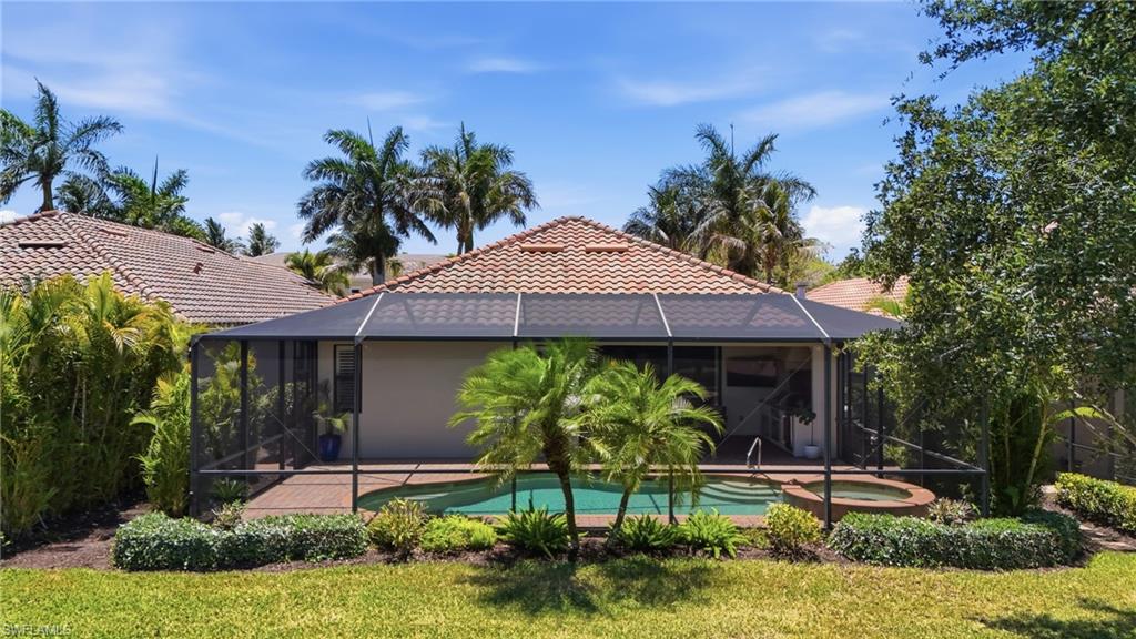 3058 Aviamar Circle Naples, FL 34114 - Photo 31 of 50 Screened lanai featuring a private pool with an integrated spa, surrounded by mature landscaping and a paver deck