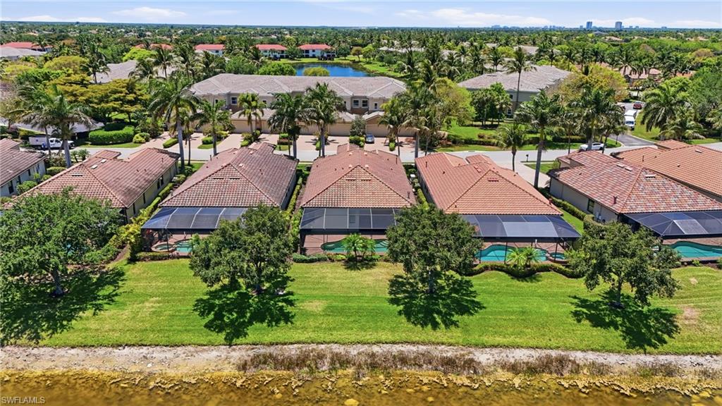3058 Aviamar Circle Naples, FL 34114 - Photo 37 of 50 Expansive residential area featuring properties with red tile roofs, enclosed screened patios, and individual swimming pools