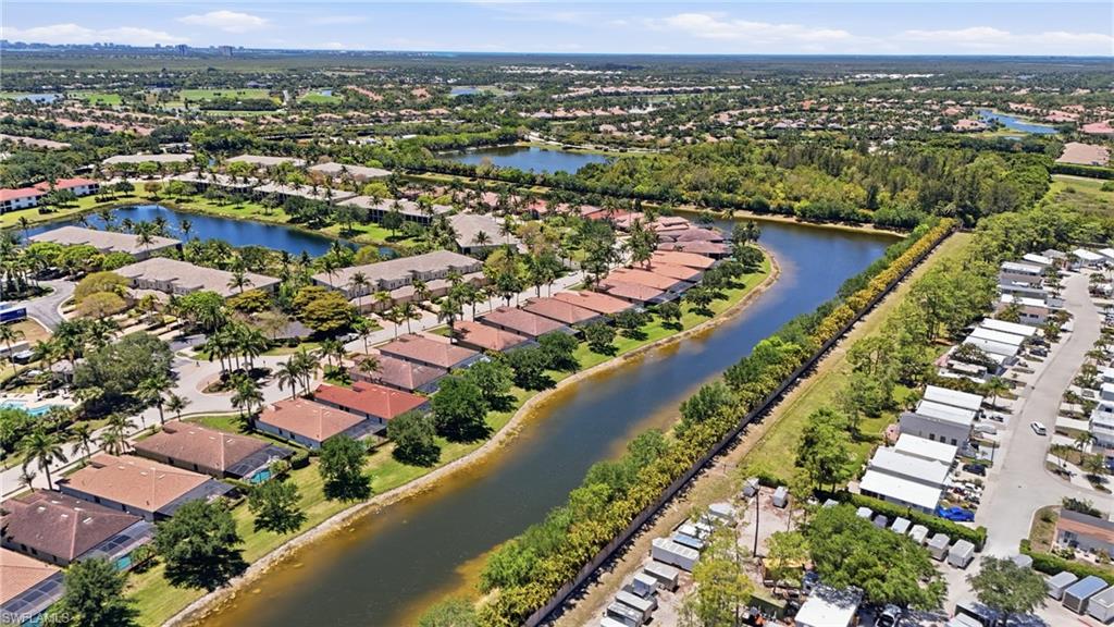 3058 Aviamar Circle Naples, FL 34114 - Photo 40 of 50 Aerial perspective showcasing a community with numerous residential properties, canals, and natural greenery