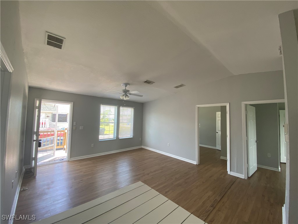 5527 Judith Road Bokeelia, FL 33922 - Photo 12 of 13 an empty room with wooden floor and windows