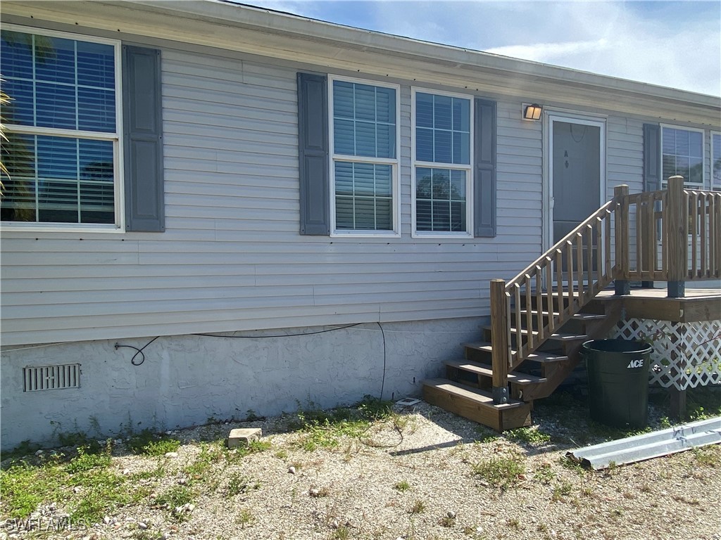 5527 Judith Road Bokeelia, FL 33922 - Photo 2 of 13 a view of a backyard with a chair and wooden floor