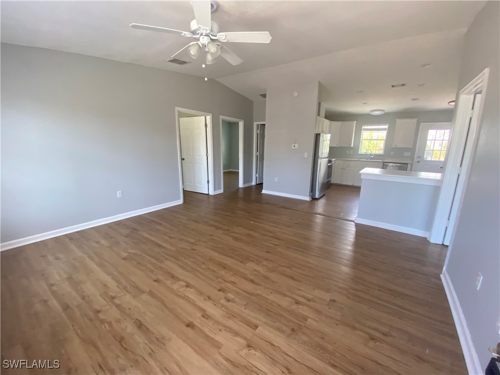 5527 Judith Road Bokeelia, FL 33922 - Photo 3 of 13 a view of an empty room with wooden floor and a ceiling fan