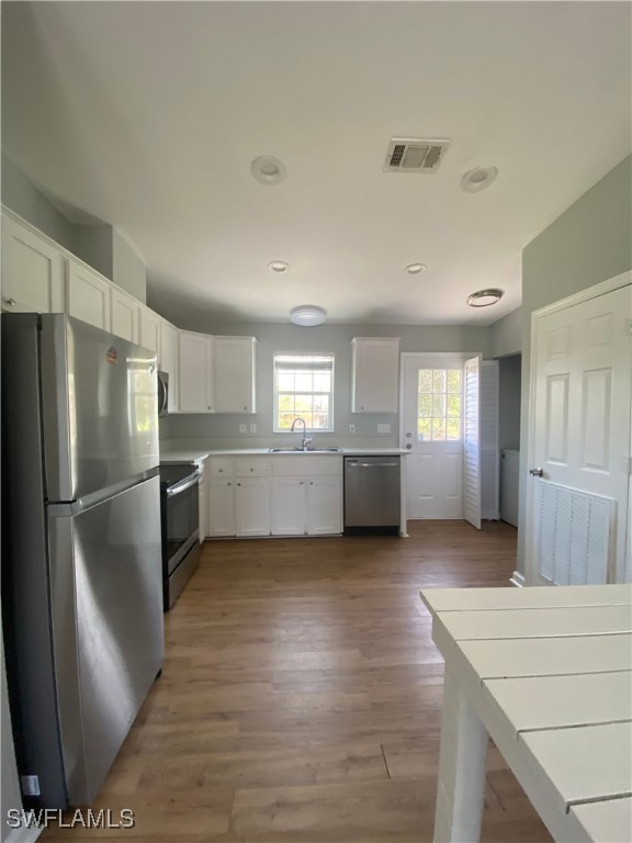 5527 Judith Road Bokeelia, FL 33922 - Photo 6 of 13 a view of a kitchen with a sink cabinet refrigerator and windows