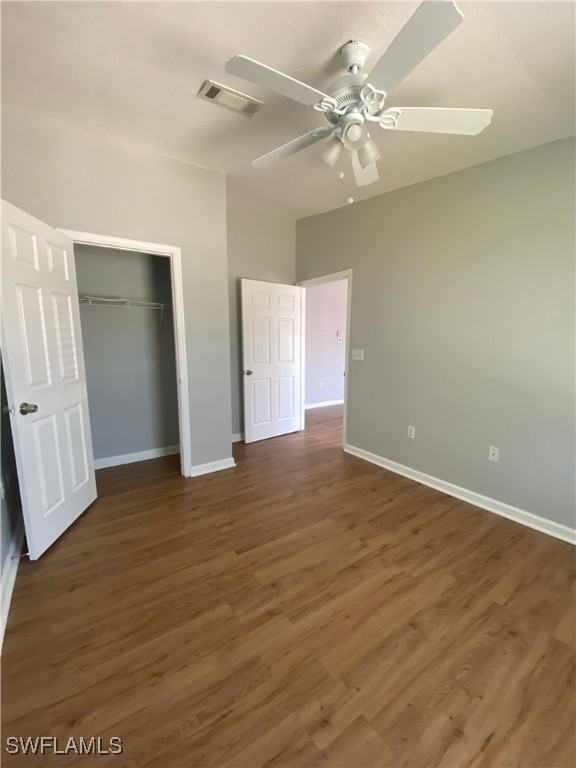 5527 Judith Road Bokeelia, FL 33922 - Photo 8 of 13 an empty room with wooden floor and ceiling fan