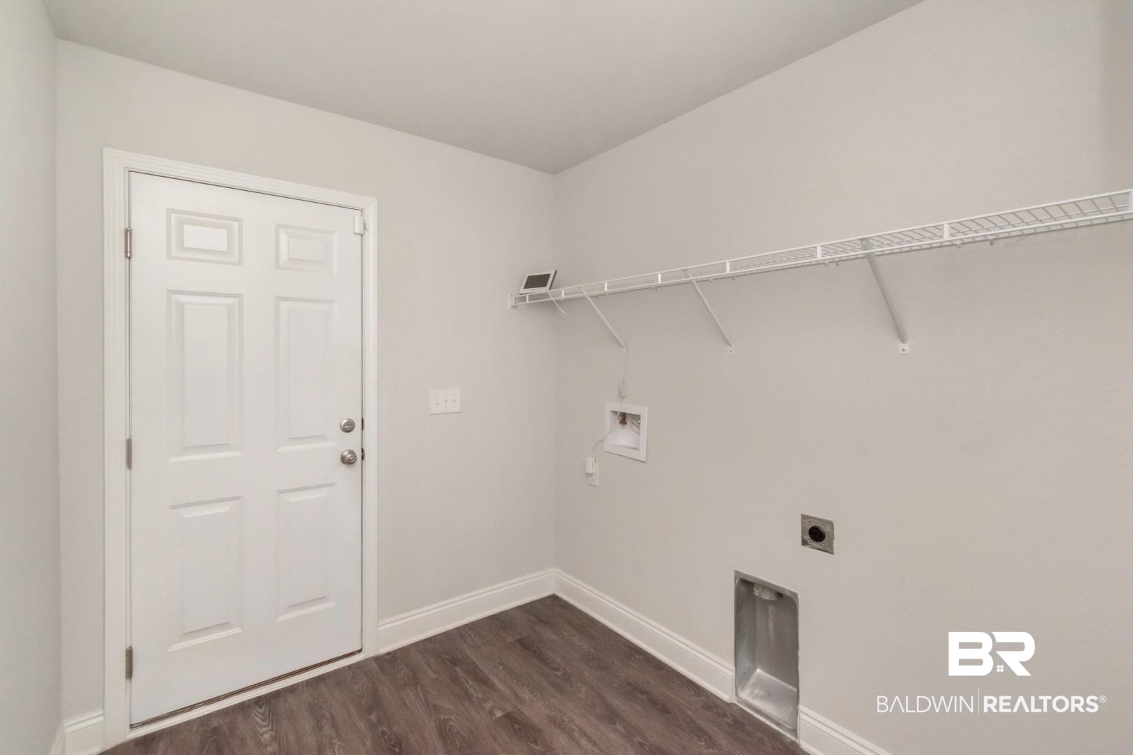 6632 Monarch Circle Mobile, AL 36618 - Photo 31 of 32 Laundry room with dark wood-style flooring, washer hookup, and electric dryer hookup