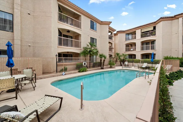 a swimming pool with outdoor seating and yard