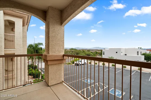 a view of a balcony with floor to ceiling windows