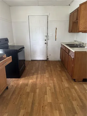 a kitchen with wooden floors and a sink