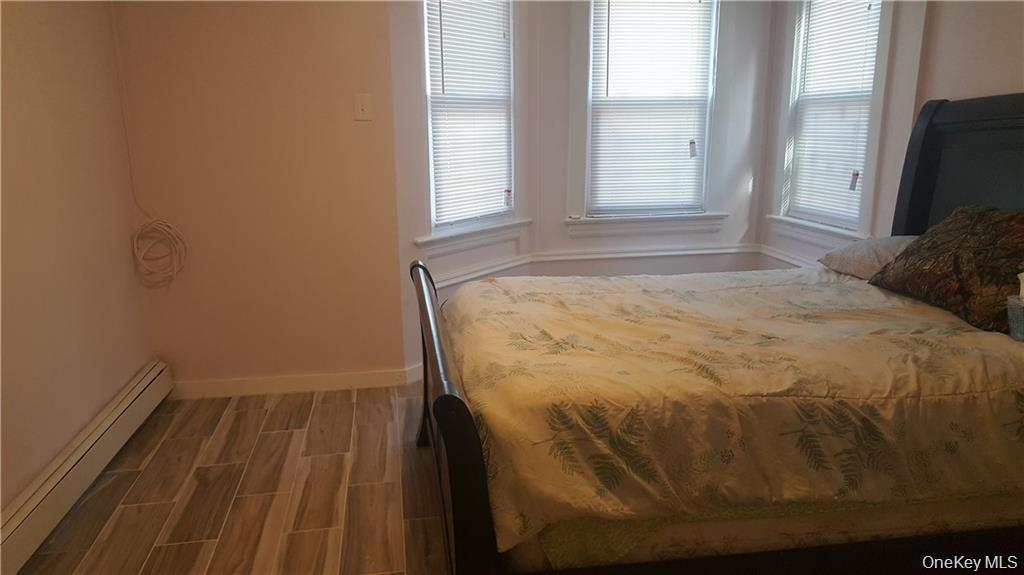 14 Horton Avenue New Rochelle, NY 10801 - Photo 7 of 29 a bed sitting in a bedroom next to a window