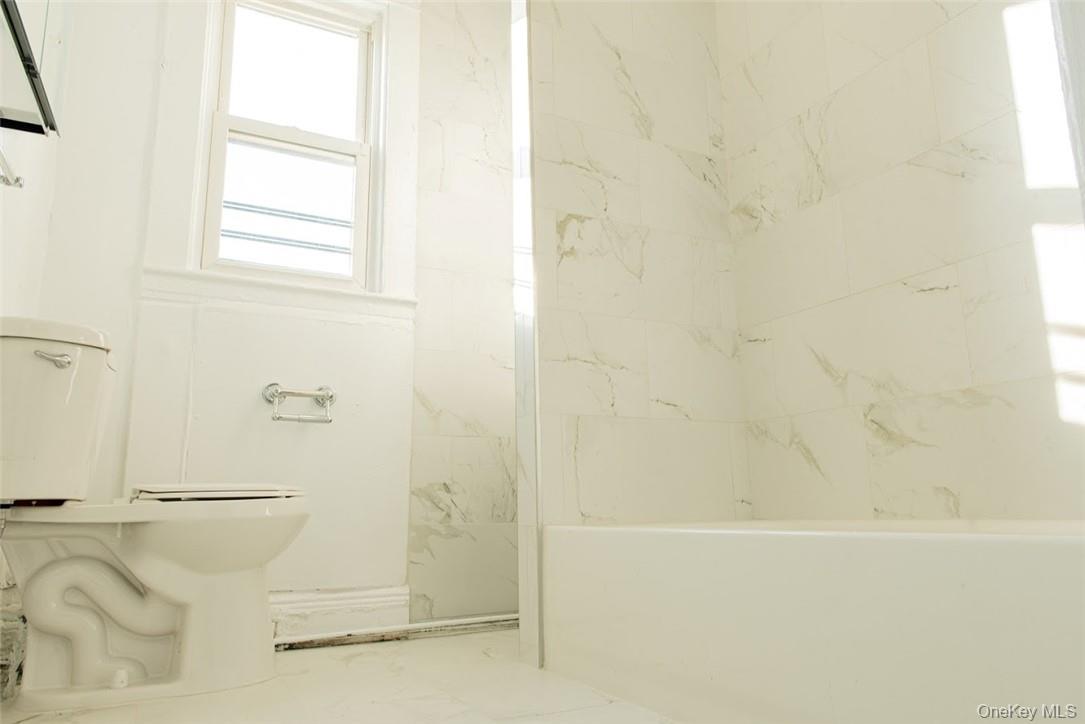 14 Horton Avenue New Rochelle, NY 10801 - Photo 10 of 29 a bathroom with a bathtub and shower