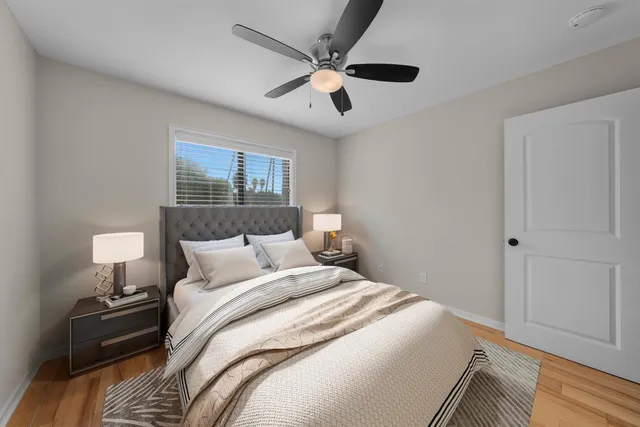 a bedroom with a large bed and a chandelier