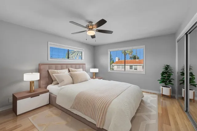 a bedroom with a large bed and a chandelier