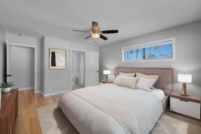 a bedroom with a large bed and a window