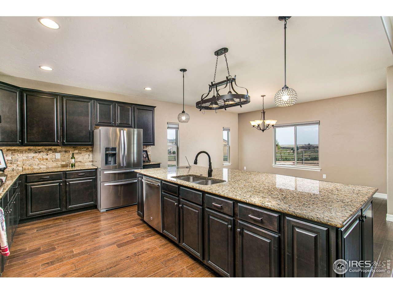 3202 Timeless Circle Berthoud, CO 80513 - Photo 13 of 40 a kitchen with stainless steel appliances granite countertop a sink stove and refrigerator