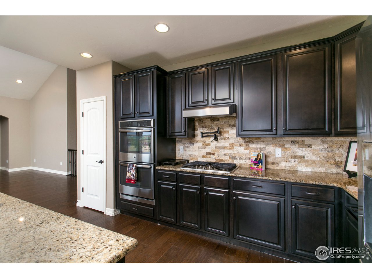3202 Timeless Circle Berthoud, CO 80513 - Photo 14 of 40 a kitchen with stainless steel appliances granite countertop a refrigerator and a sink