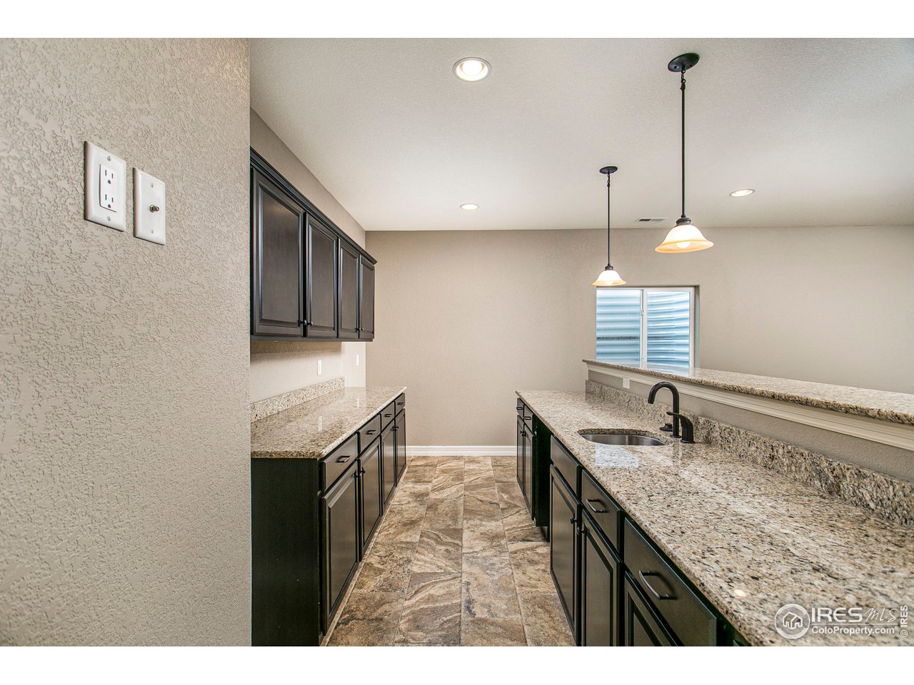 3202 Timeless Circle Berthoud, CO 80513 - Photo 27 of 40 a kitchen with granite countertop cabinets a sink a window and stainless steel appliances