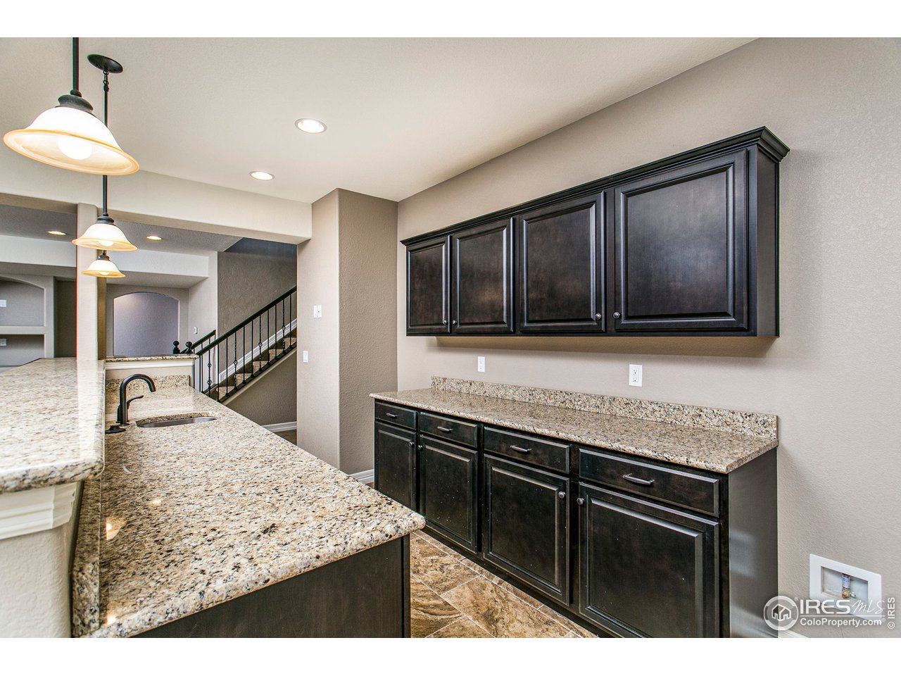 3202 Timeless Circle Berthoud, CO 80513 - Photo 28 of 40 a kitchen with stainless steel appliances kitchen island granite countertop a stove top oven and sink