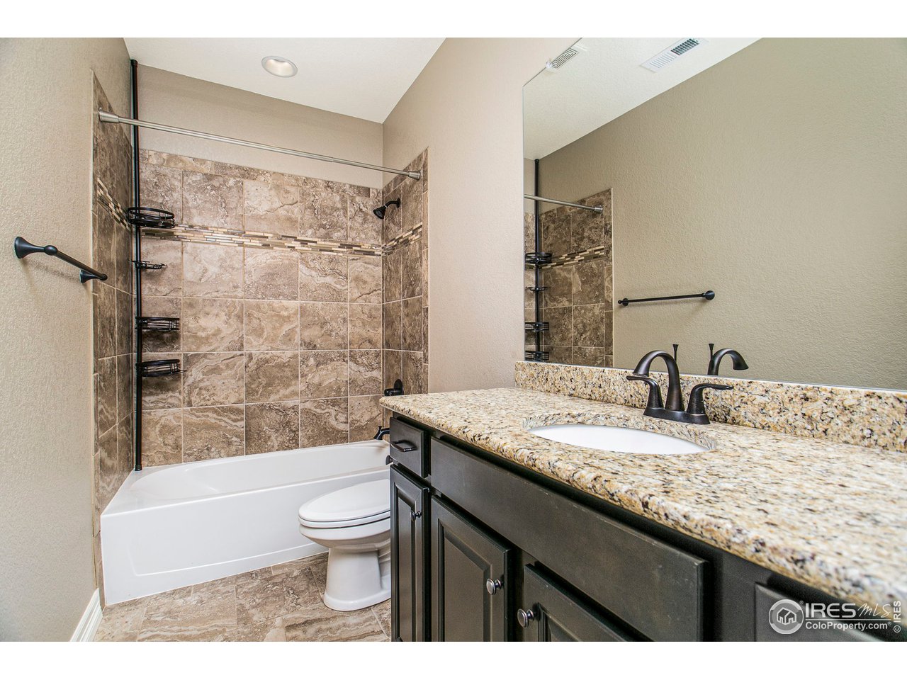 3202 Timeless Circle Berthoud, CO 80513 - Photo 30 of 40 a bathroom with a granite countertop sink toilet and shower