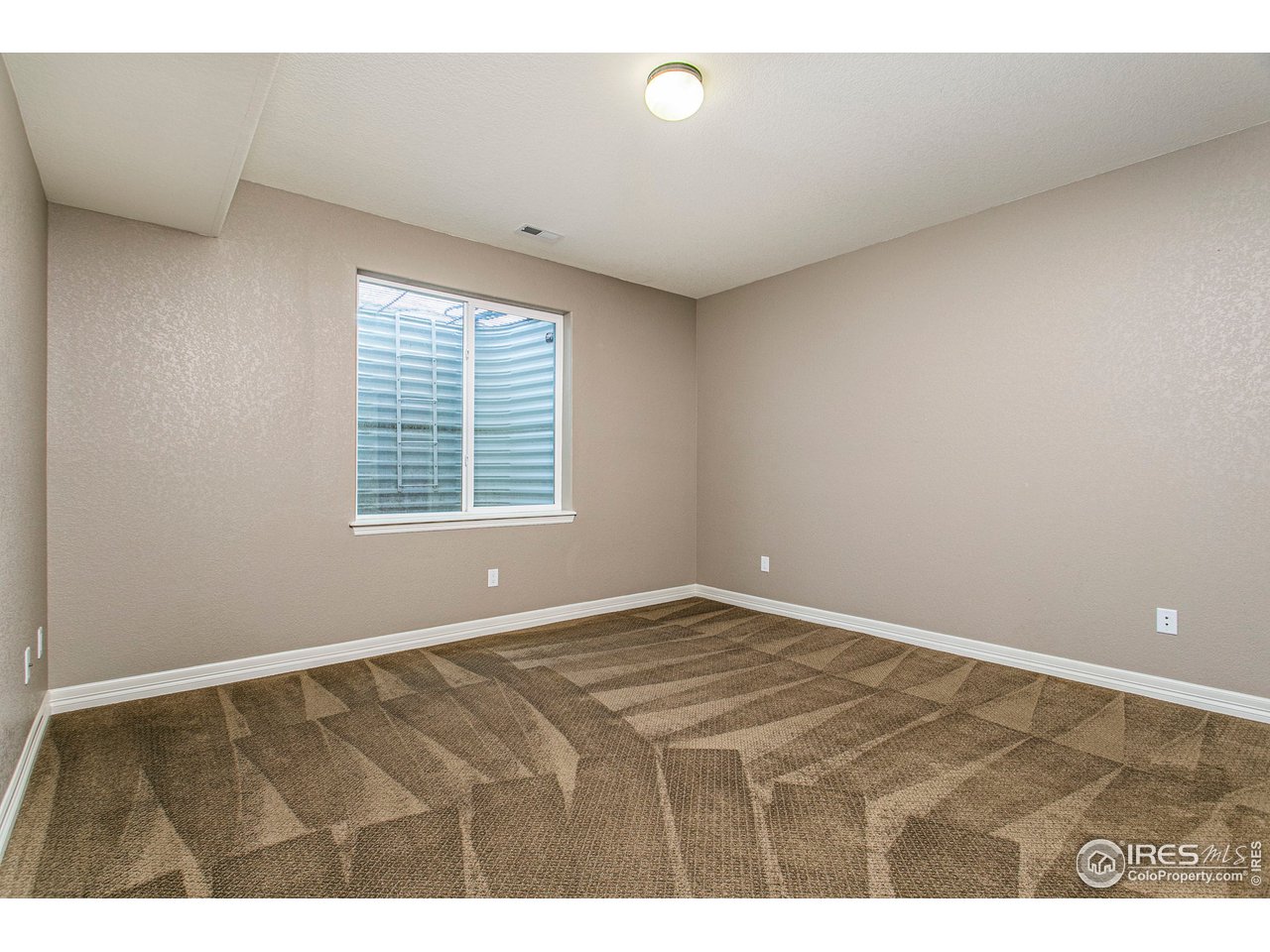 3202 Timeless Circle Berthoud, CO 80513 - Photo 31 of 40 a view of an empty room with a window