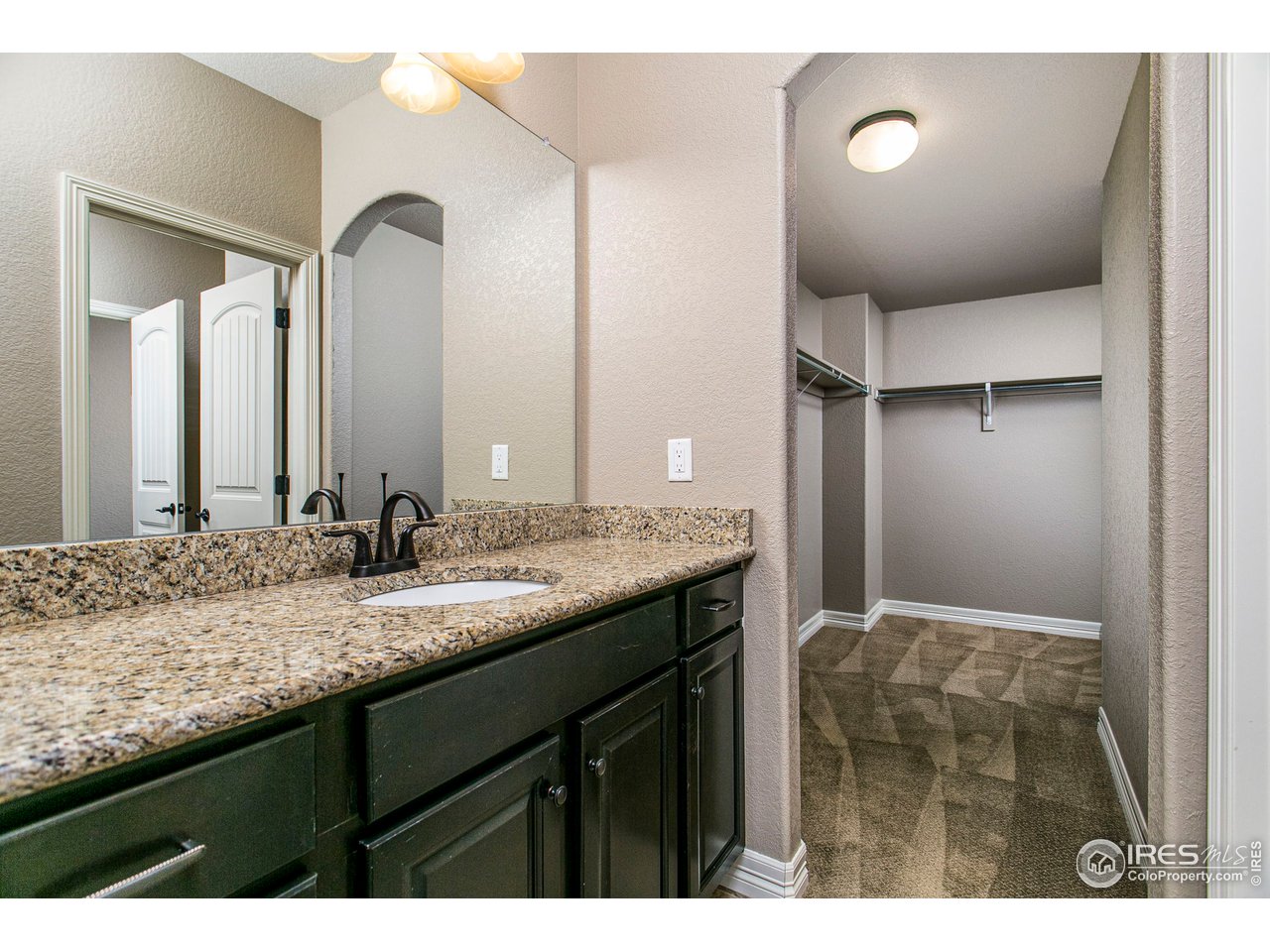3202 Timeless Circle Berthoud, CO 80513 - Photo 32 of 40 a bathroom with a granite countertop sink and a mirror