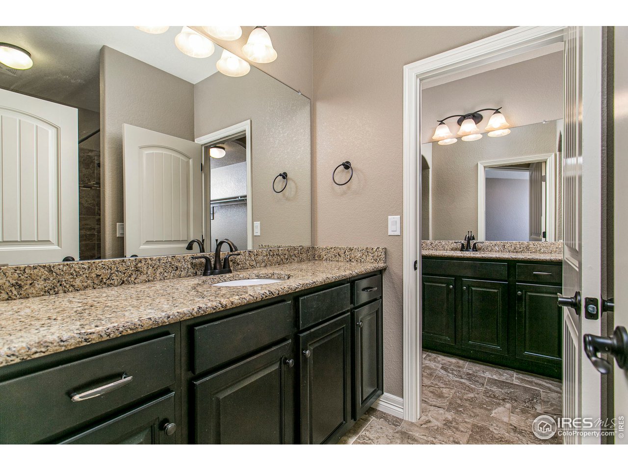 3202 Timeless Circle Berthoud, CO 80513 - Photo 33 of 40 a bathroom with a granite countertop sink and a mirror