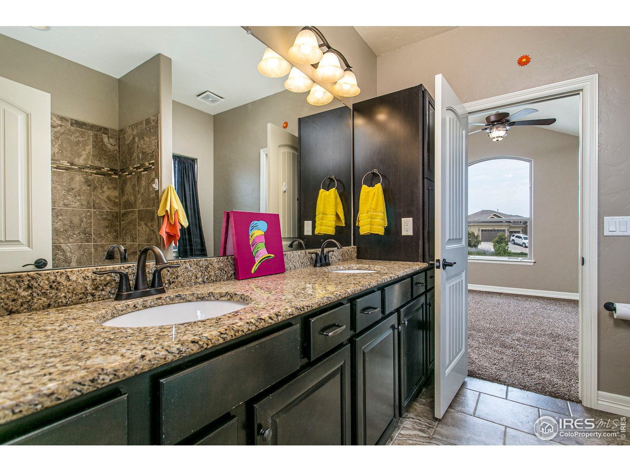 3202 Timeless Circle Berthoud, CO 80513 - Photo 8 of 40 a bathroom with a granite countertop sink vanity and a mirror