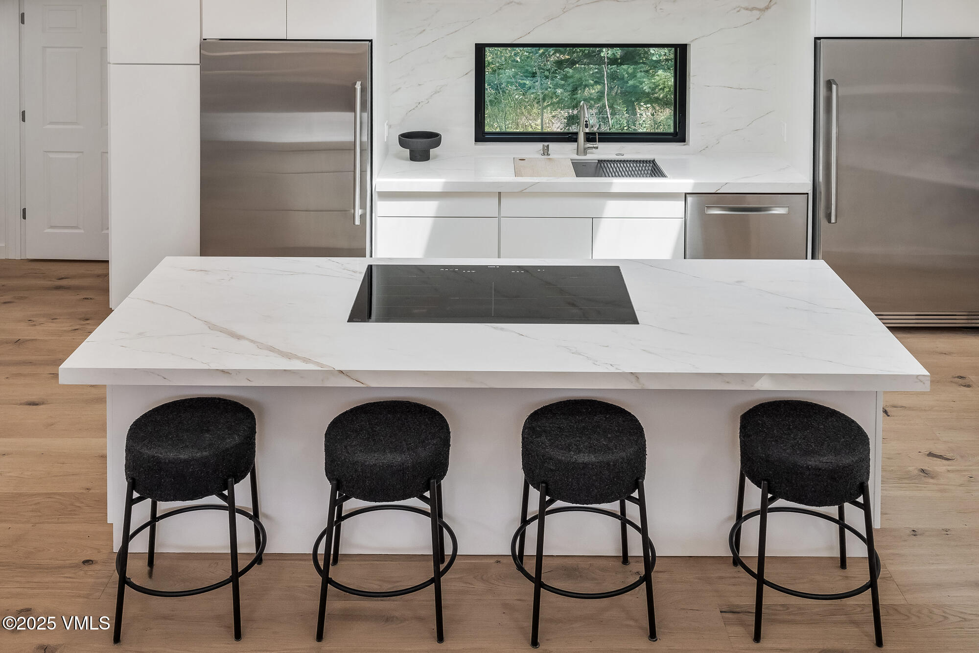 4545 Big Horn Road Vail, CO 81657 - Photo 19 of 49 a kitchen with stainless steel appliances a table chairs and a refrigerator