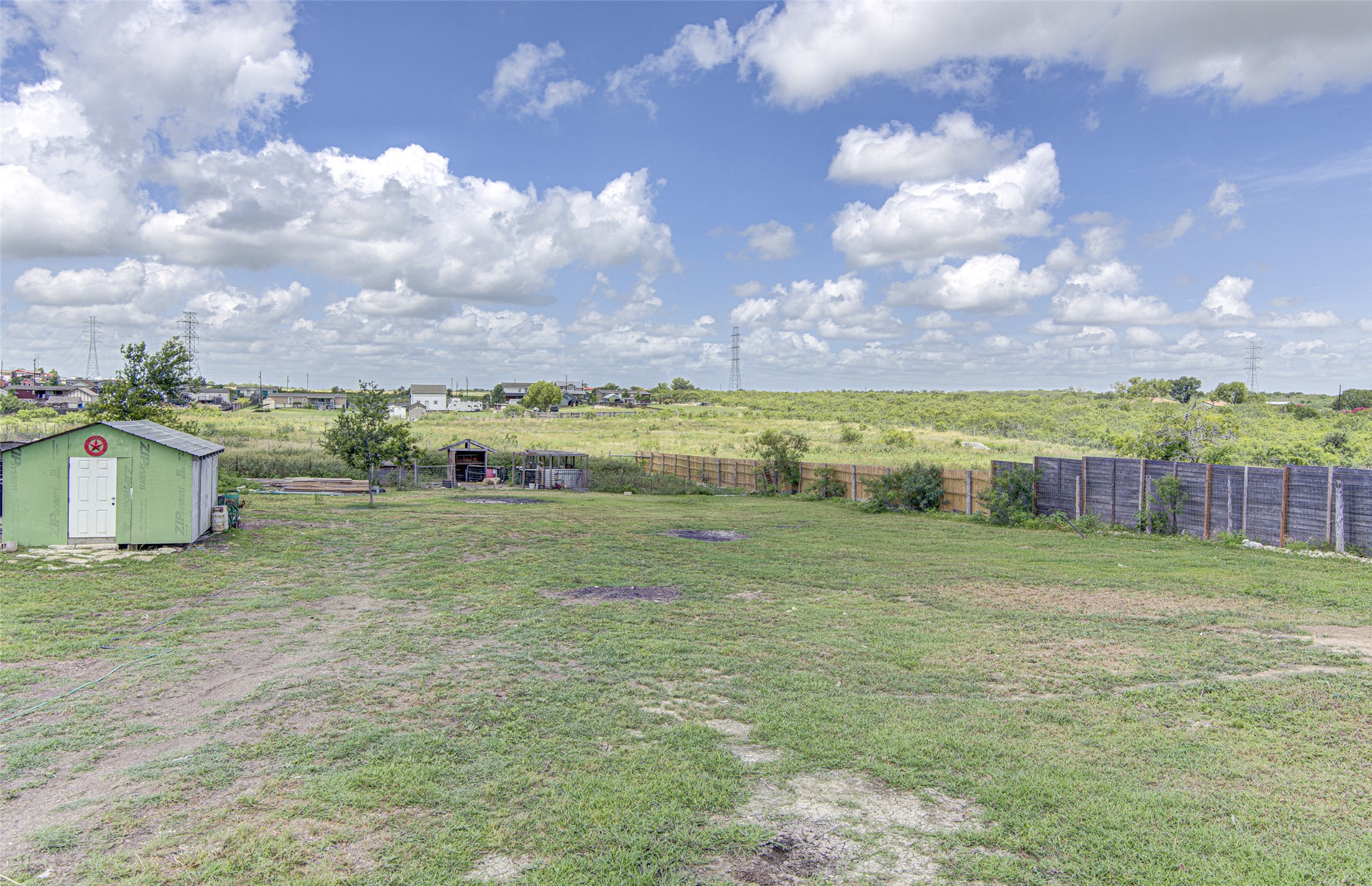 445 Rancho Linda Drive Lockhart, TX 78644 - Photo 6 of 26 A spacious backyard with a utility shed and fenced perimeter offers abundant outdoor living potential.