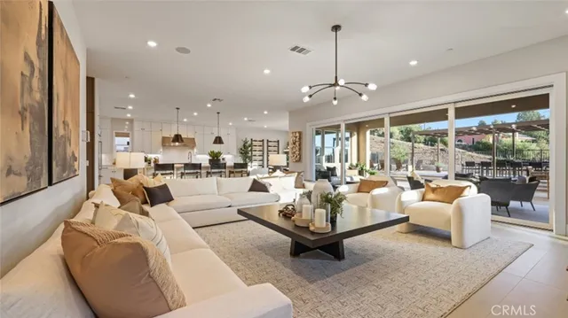 a living room with fireplace furniture and a large window