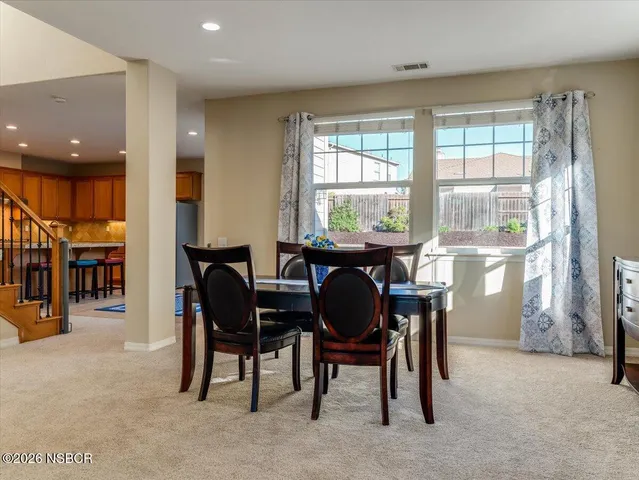 a dining room with furniture and window