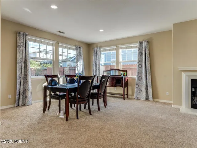 a view of a dining room with furniture and window