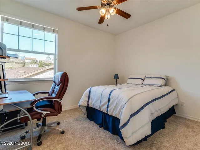 a bedroom with a bed and a chair