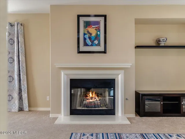 a living room with a fireplace and a fireplace