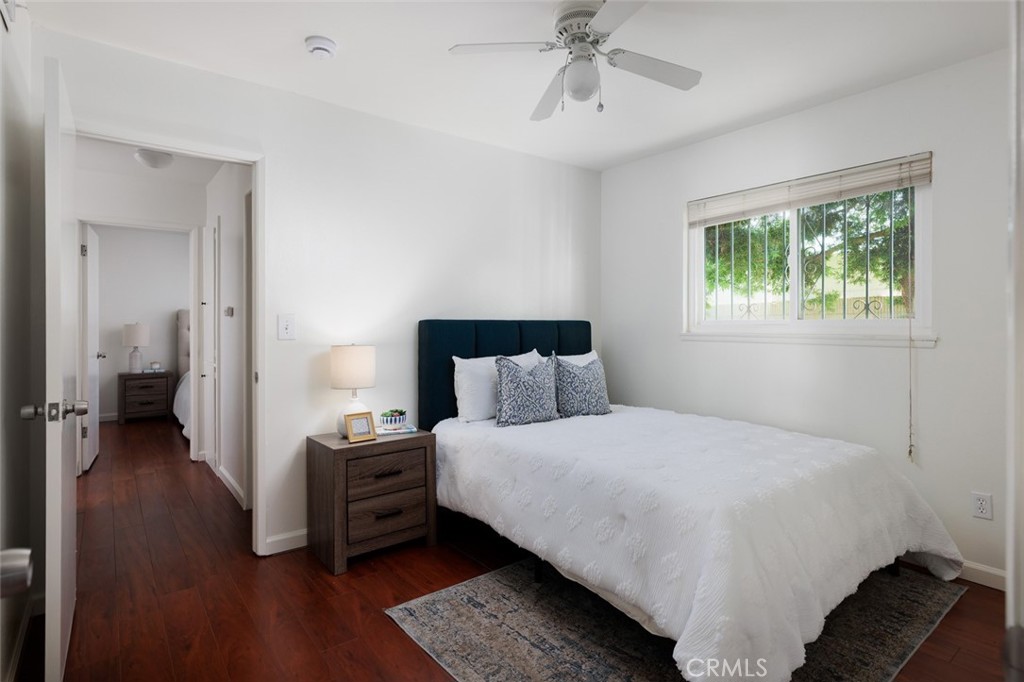 7901 Rhine Drive Huntington Beach, CA 92647 - Photo 12 of 19 a bedroom with a bed and a chandelier