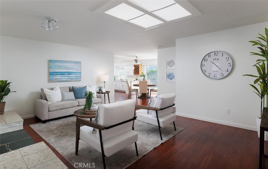 7901 Rhine Drive Huntington Beach, CA 92647 - Photo 3 of 19 a living room with furniture a clock and a window