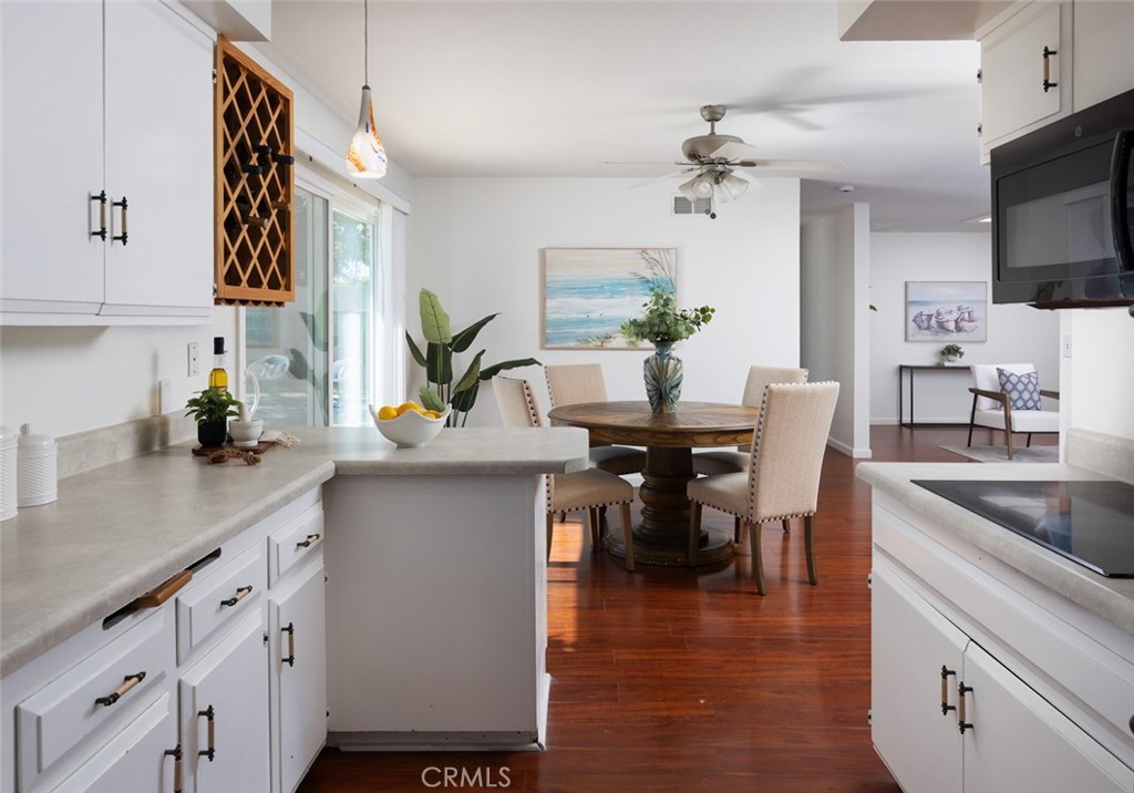 7901 Rhine Drive Huntington Beach, CA 92647 - Photo 7 of 19 a kitchen with kitchen island granite countertop a sink a stove and cabinets