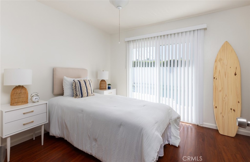 7901 Rhine Drive Huntington Beach, CA 92647 - Photo 8 of 19 a bedroom with a bed and wooden floor