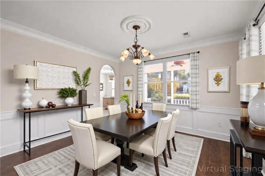 2935 Cobblestone Drive Cumming, GA 30041 - Photo 12 of 53 a dining room with furniture a rug and wooden floor