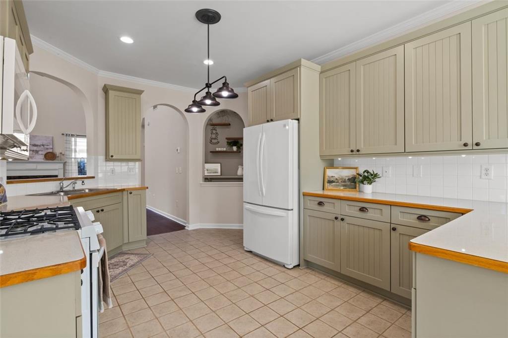 2935 Cobblestone Drive Cumming, GA 30041 - Photo 21 of 53 a kitchen with a refrigerator a stove a sink and a cabinets
