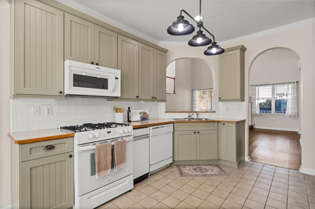 2935 Cobblestone Drive Cumming, GA 30041 - Photo 22 of 53 a kitchen with stainless steel appliances granite countertop a stove a sink and a microwave