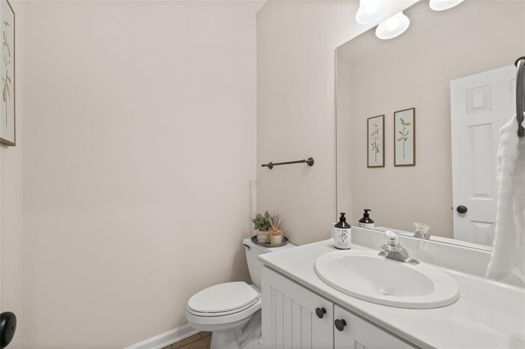 2935 Cobblestone Drive Cumming, GA 30041 - Photo 26 of 53 a bathroom with a sink a toilet and mirror
