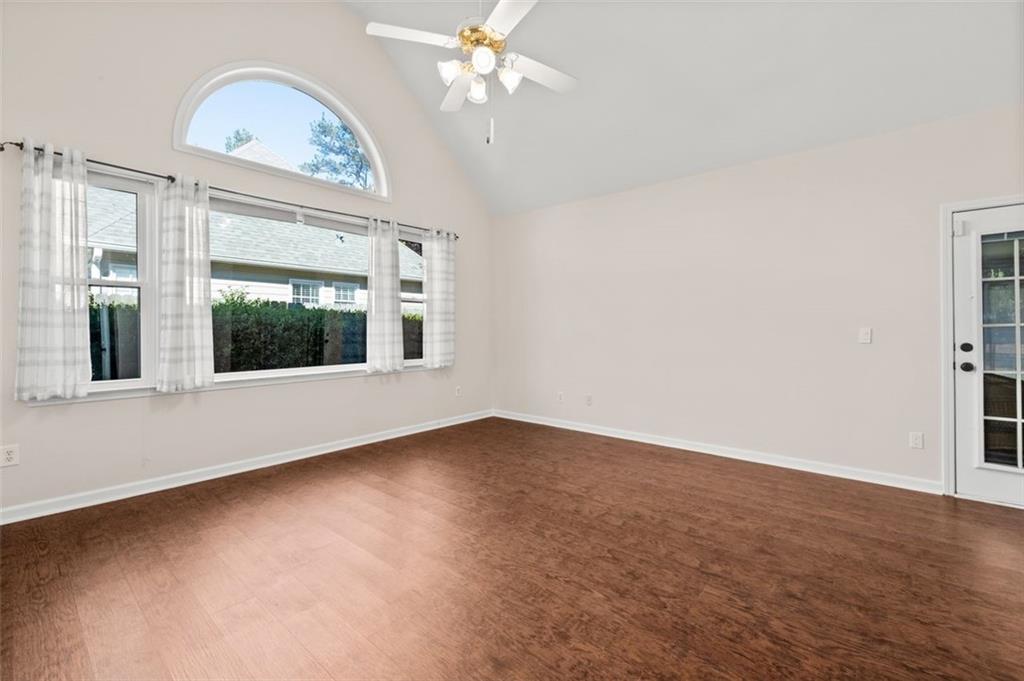 2935 Cobblestone Drive Cumming, GA 30041 - Photo 27 of 53 an empty room with chandelier fan and windows