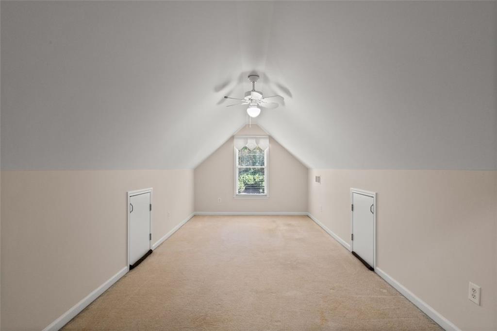 2935 Cobblestone Drive Cumming, GA 30041 - Photo 42 of 53 an empty room with chandelier fan and windows
