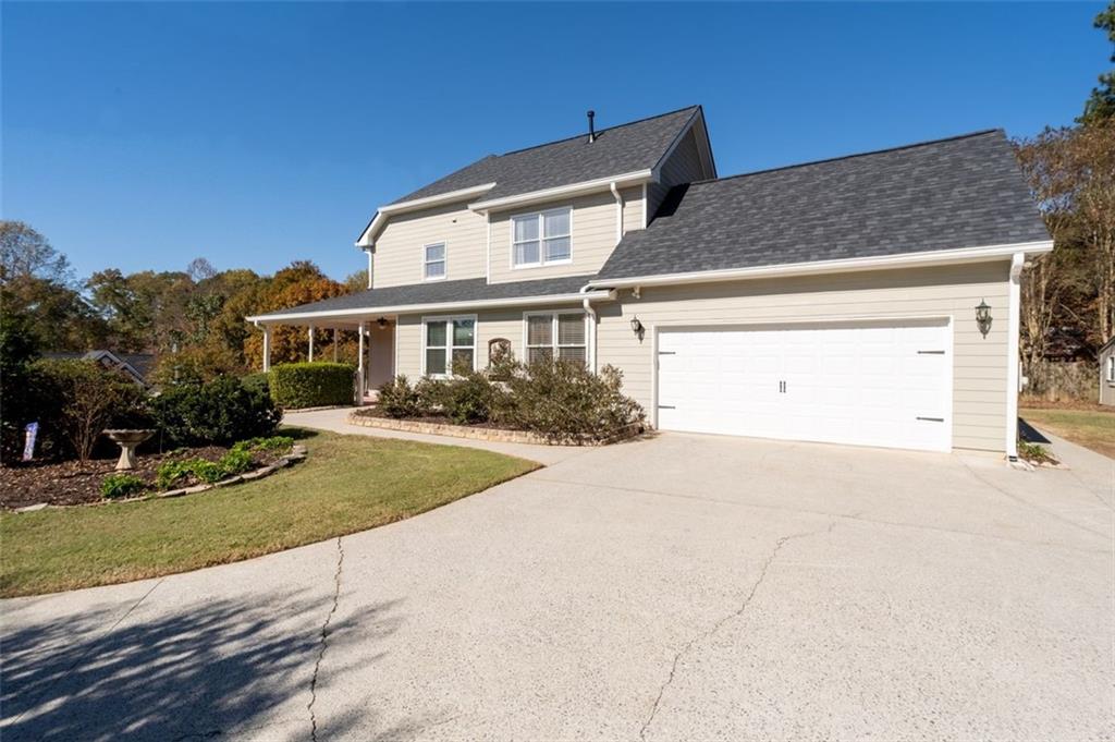 2935 Cobblestone Drive Cumming, GA 30041 - Photo 45 of 53 a front view of a house with a yard and garage