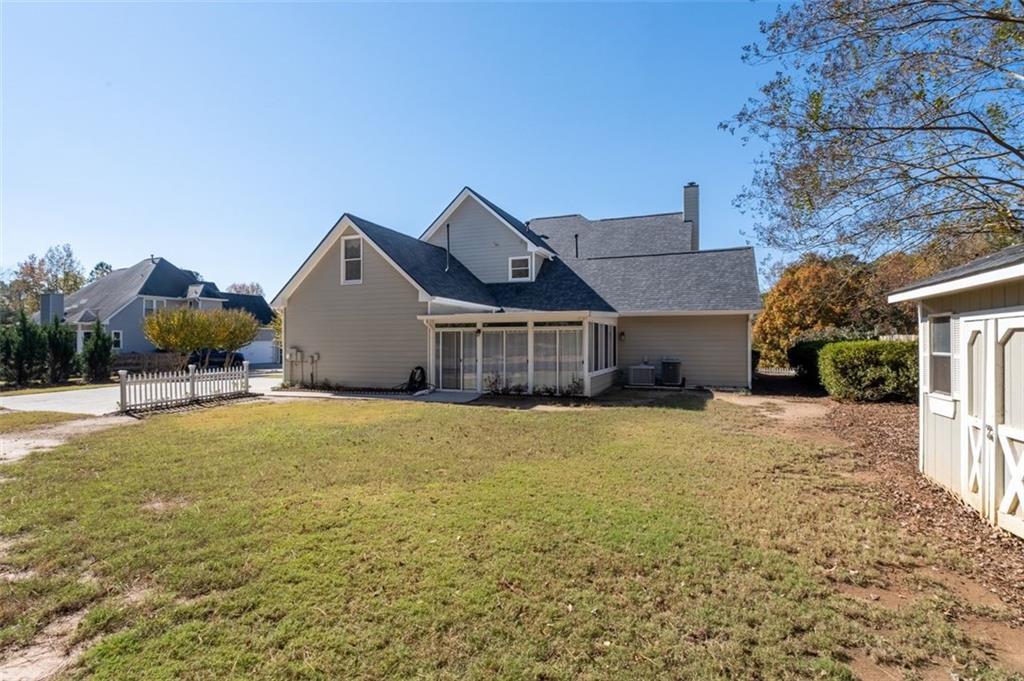 2935 Cobblestone Drive Cumming, GA 30041 - Photo 48 of 53 a front view of house with yard and trees in the background