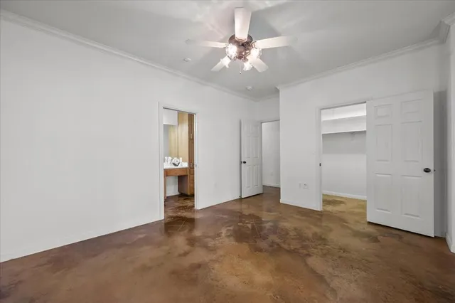 a view of an empty room with a ceiling fan