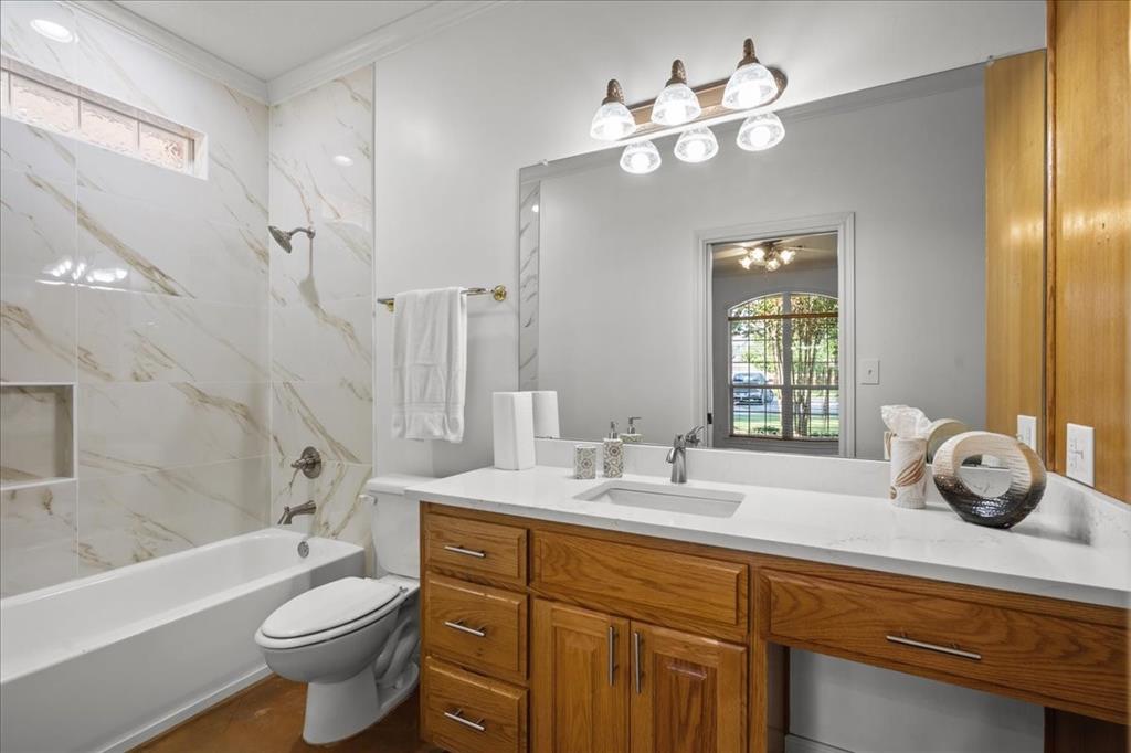 8300 Jonquil Drive Waco, TX 76708 - Photo 16 of 40 a bathroom with a sink a toilet and a bathtub