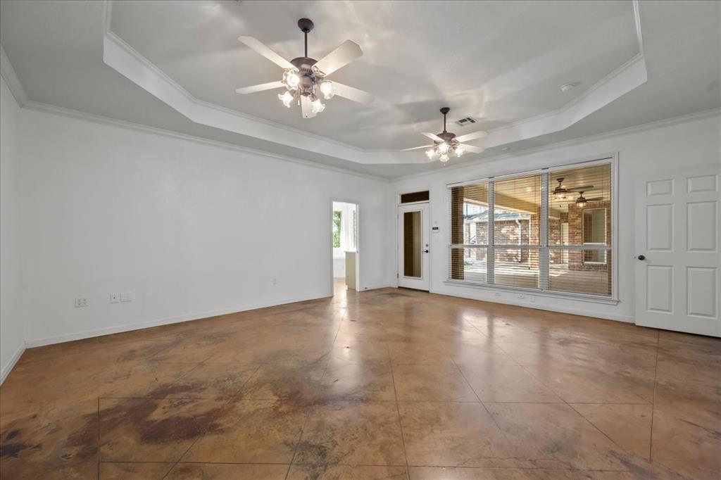 8300 Jonquil Drive Waco, TX 76708 - Photo 19 of 40 an empty room with chandelier fan and windows
