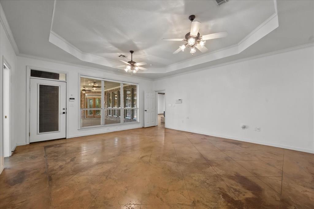 8300 Jonquil Drive Waco, TX 76708 - Photo 20 of 40 a view of an empty room with a chandelier fan